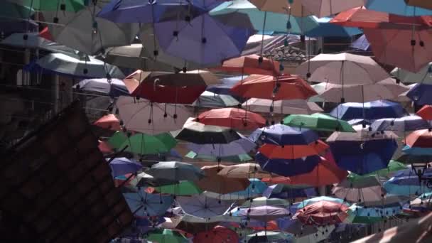 Colourful umbrellas are hanging on the rope between buildings, Catania, new airport of Istanbul — Stock Video