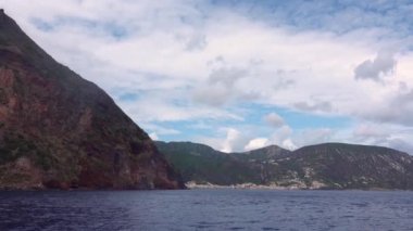 Deniz kıyısındaki deniz manzarasında yelkenli yatı manzarası. İtalya. Lipari Adaları, Sicilya, İtalya