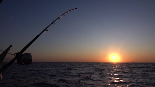 Mediterranean sea, sunset and horizon, fishing rod with reel. Slow motion — Stock Video