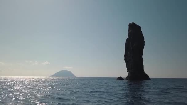 Aerial view on high rock in Mediterranean sea against horizon and Lipari Island. Blue sky, sunset. Sicily, Italy — Stock Video