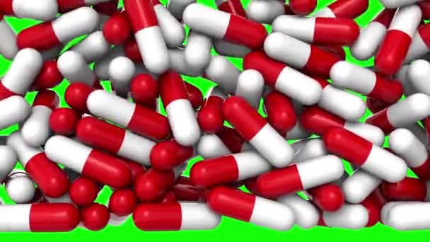 Beyaz ve kırmızı ilaç kapsülleri yeşil ekrana karşı yığılıp kalıyor. Parlak yakın plan arkaplan ve alfa kanalı ile 3D görüntüleme. Geçiş efekti. — Stok video