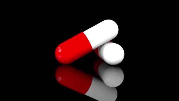 Dos cápsulas farmacéuticas rojas blancas se cierran aisladas sobre un fondo negro. Renderizado 3D giratorio. Animación estilo dibujos animados con canal alfa . — Vídeo de stock