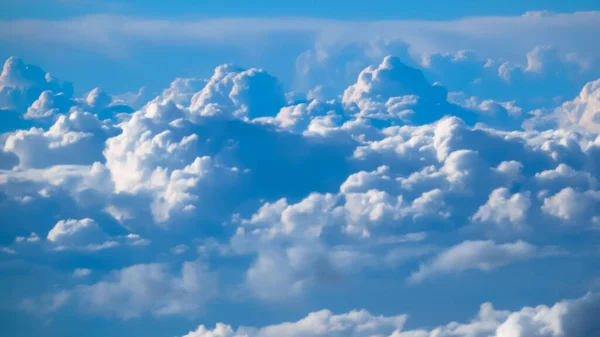 Nice footage of aerial view above clouds from airplane window with blue sky. — Stock Photo, Image