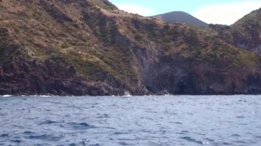 Dalgalar kayalık dağlarda kırılıyor. Turkuaz gökyüzü, Akdeniz