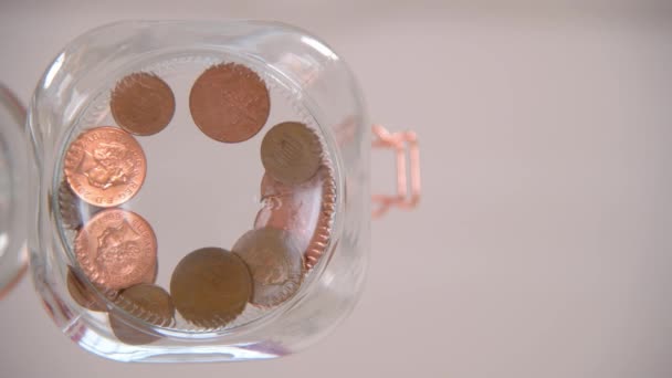 Worm Eye View Someone Dropping Pennies Glass Jar — Stock Video