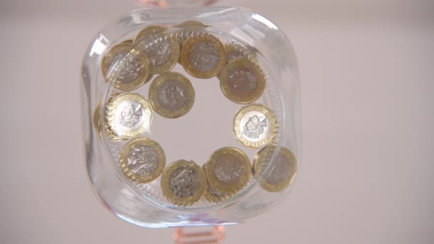 Worm Eye View Someone Putting Pound Coins Glass Jar — Stock Video