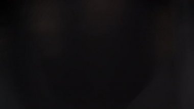 A tracking shot revealing a professional designer sketching out a design in a sketchbook at a desk