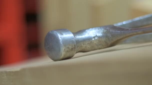 Tilted handheld slow motion shot for a hammer left on a workbench