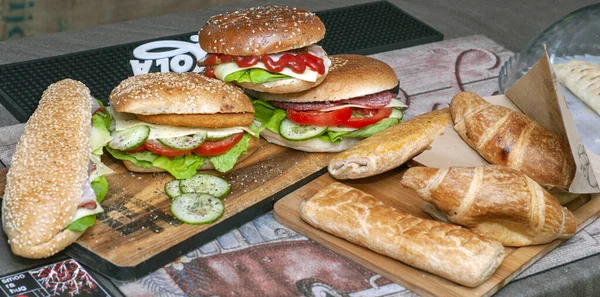 Fresh baguette sandwiches. chicken, bacon, roasted cheese, tomatoes, cucumber and lettuce
