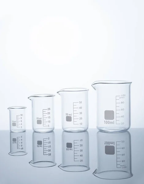 Four empty measuring beakers