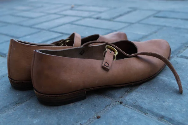 Bir çift kadın derisi, el yapımı dans ayakkabısı fayans üzerinde duruyor.