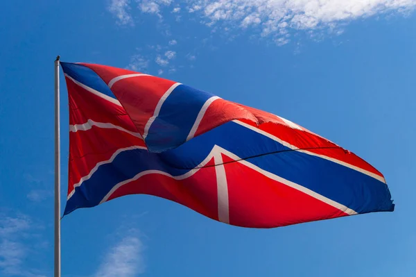 İngiliz bayrağı, mavi gökyüzüne doğru sallanan güneşin ışığıyla aydınlandı.