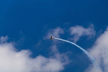 Aerobatics: performance at a competition of a single-seat sports aerobatic airplane, which shows stunts in the sky clipart