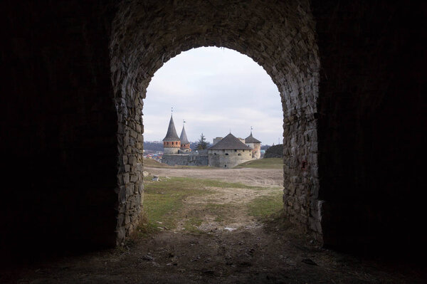 View of the Kamyanets-Podilsky fortress from the arch of stone fortifications around the castle