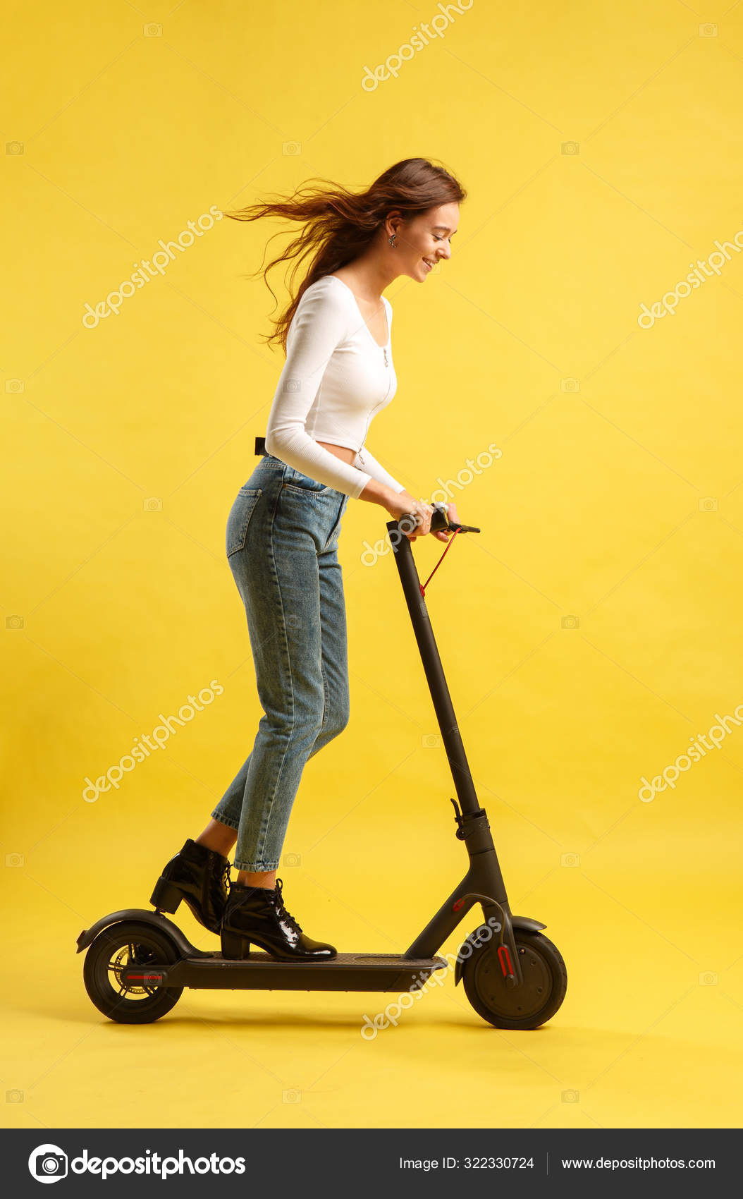 Young beautiful girl with scooter. Isolated on yellow background. Technology freedom of movement. Stock Photo by ©georgeeb22