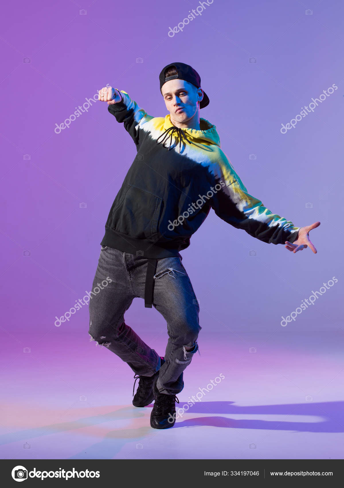 Breakdancing young man in hoodie and baseball cap. Dance school poster.  Copy space. Battle competition announcement. Stock Photo by ©georgeeb22  334197046