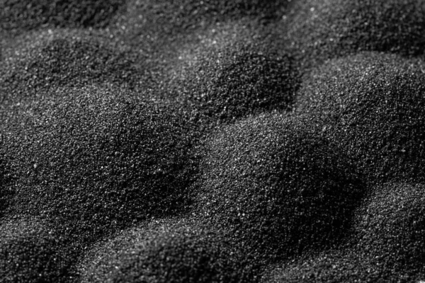 Black sand dunes background. Bump trace. Creative sand relief.