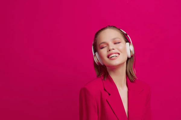Een mooi jong meisje in een draadloze hoofdtelefoon luistert naar liedjes met een goed humeur. heldere kleurrijke muziek poster. — Stockfoto