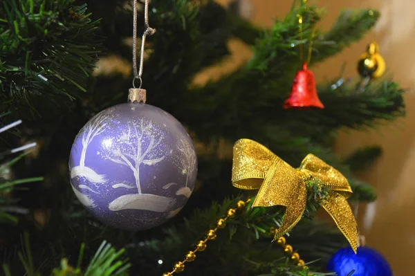 Christmas toys to decorate the spruce. yellow beads, yellow bow and ornate ball