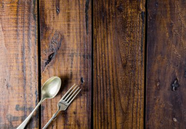 Kırsal ahşap bir masa üzerine çatal bıçak seti. Çatal, kaşık. Yemek konsepti. Boşluğu Kopyala