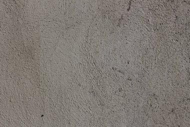 Rough curved lines on gray plaster wall
