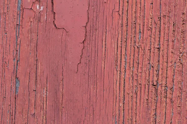 Texture de vieux bois avec peinture rouge fissurée pelant — Photo