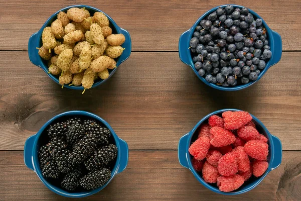 Four bowls with berries — Stock Photo, Image