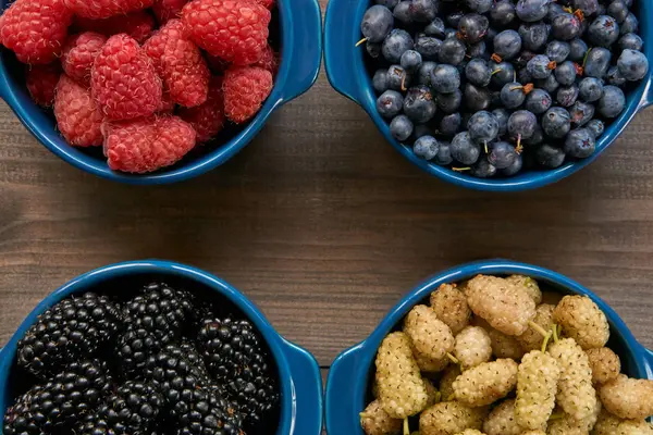 Macro closeup from the top. four bowls with berries — Stock Photo, Image
