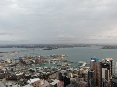 Viaduct Harbour, Auckland / New Zealand - December 31, 2019: The iconic Skytower landmark of Auckland City and its surrounding buildings