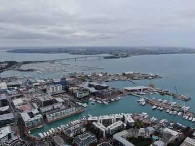 Viaduct Harbour, Auckland / New Zealand - December 31, 2019: The iconic Skytower landmark of Auckland City and its surrounding buildings