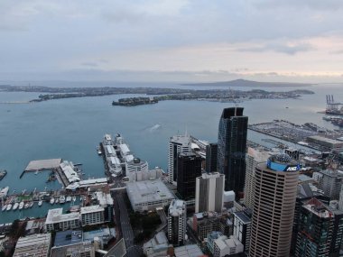 Viaduct Harbour, Auckland / New Zealand - December 31, 2019: The iconic Skytower landmark of Auckland City and its surrounding buildings