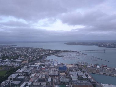 Viaduct Harbour, Auckland / New Zealand - December 31, 2019: The iconic Skytower landmark of Auckland City and its surrounding buildings