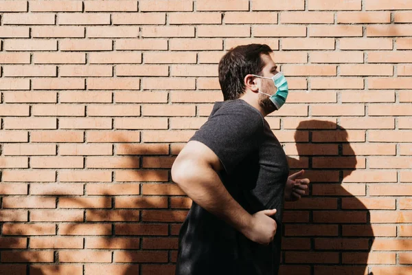 Man practices running with a medical mask