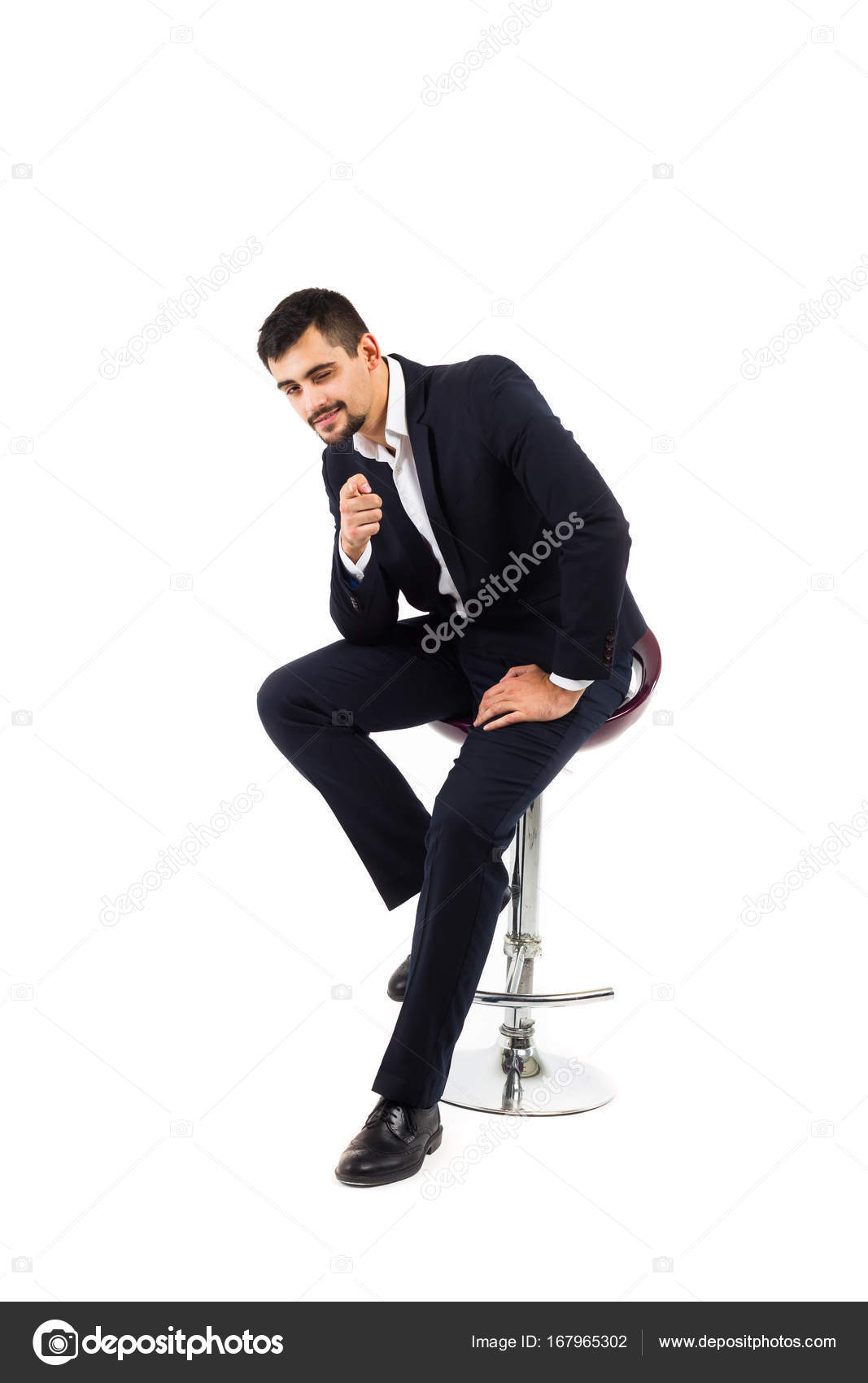 A Young Man Sits On Bar High Chair Business Suit Serious A Young Man Sits On Bar High Chair Business Suit Serious Look Is Inexhaustible Or Financier An Office Employee Isolate White Background