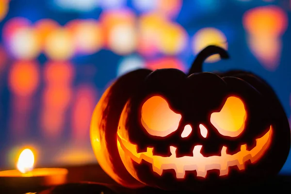 Spooky pumpkin head jack o' lantern glowing with a burning candl — Stock Photo, Image