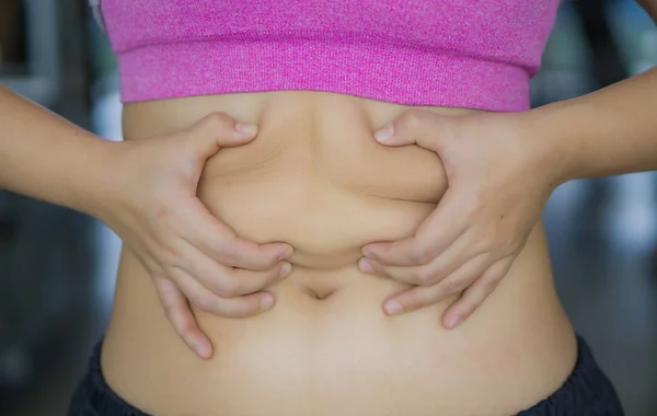Close up woman holding excessive fat belly. Woman overweight abd