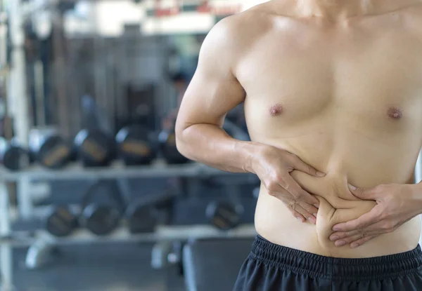 Close up man holding excessive fat belly. Man overweight abdomen