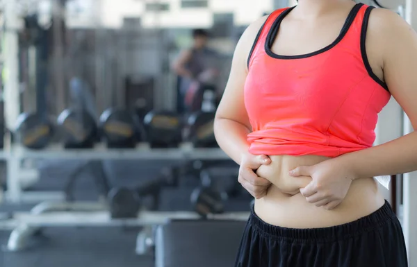 Close up woman holding excessive fat belly. Woman overweight abd