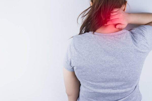 Closeup woman suffering from neck and shoulder pain with red spo