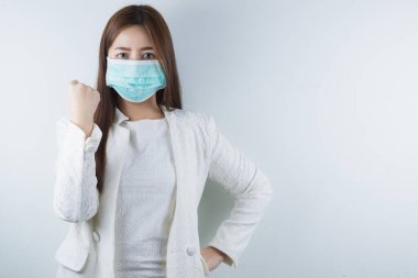 Coronavirus 'u ve PM 2.5' u korumak için maske takan ve onlarla savaşmak için elini gösteren iş kızı. Coronavirus ve Hava Kirliliği Öğleden Sonra 2.5 kavramı.