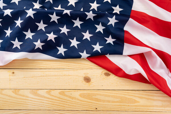 US American flag on wooden background. For USA Memorial day, Presidents day, Veterans day, Labor day, Independence or 4th of July celebration. Top view, copy space for text.