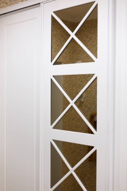 Built-in closet in the hallway, door ornament, square shapes.