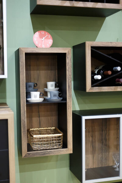 Decorative shelves on a green wall. Side view.