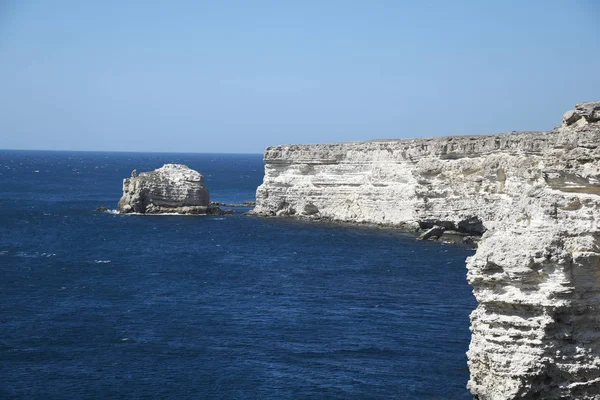 High coast, a cliff overhangs the sea, a stone coast.