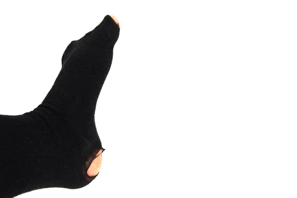 Topuğunda Başparmağında Delik Olan Siyah Taytlı Bir Bacak Çökme Kavramı — Stok fotoğraf