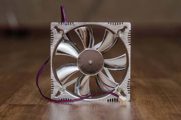 aluminum fan, cooler for computer on a wooden floor