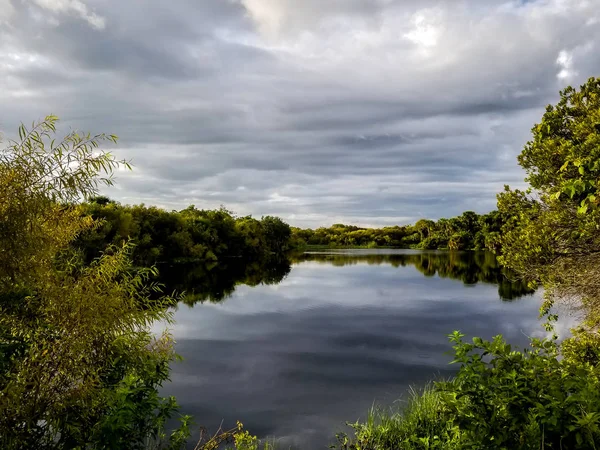 The calm waters of the Myakka River in southwest Florida reflecting the clouds.