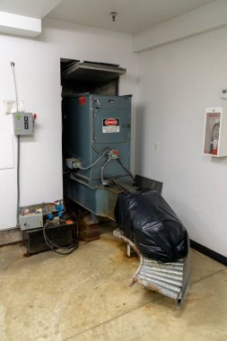 Suffern, NY / United States - March 17 2020: Vertical image of an apartment building's trash compactor.