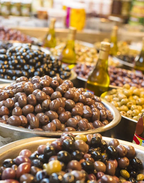 Diferrent olives and olive oil at market Royalty Free Stock Photos