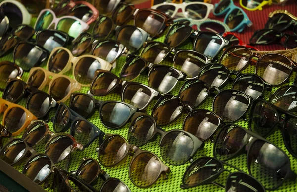 Different fashion options sunglasses on the counter of the store. (Selective focus) — Stock Photo, Image